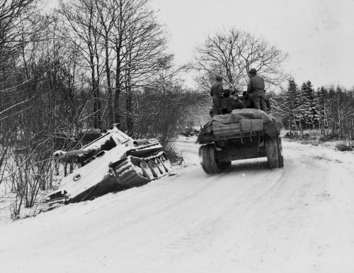2nd_Armored_Division_M4_Sherman_passes_german_Panther_tank_Grandmenil_BelgiumBulge.jpg