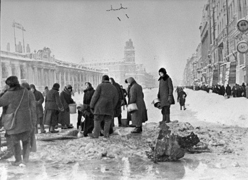 people-in-besieged-leningrad-taking-water-from-shell-holes-location-nevsky-prospect-between-gostiny-dvor-the-long-building-on-t